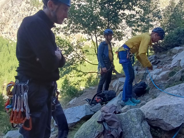Grimpeurs préparant leur matériel au pied des Écrins avec vue sur les sommets, été 2025